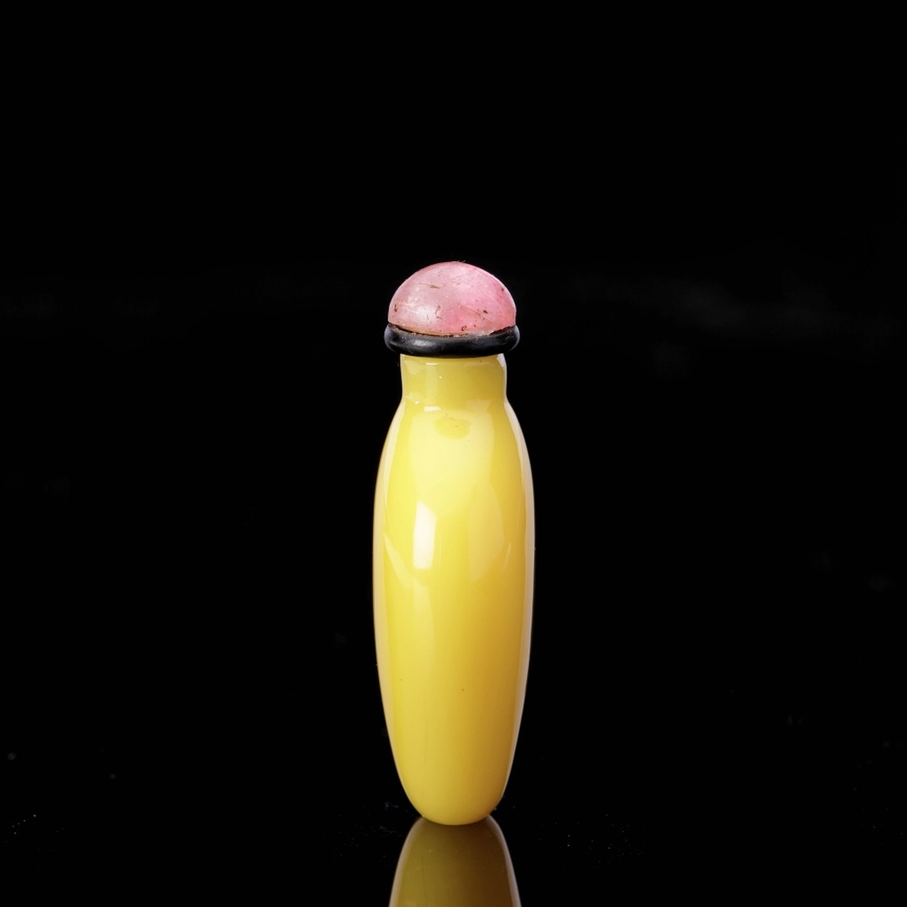 A miniature yellow glass snuff bottle