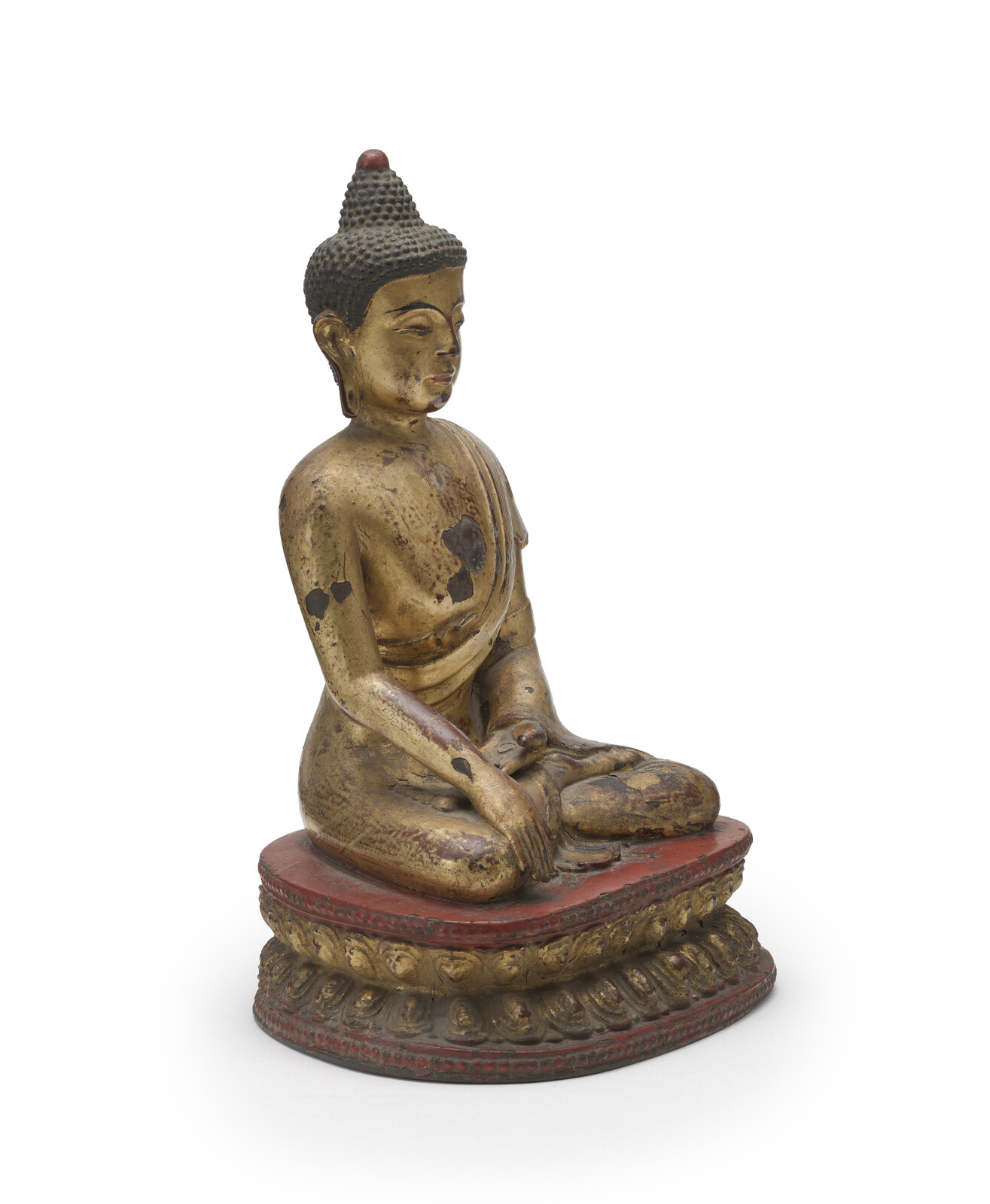 WF 21 A gilt and lacquered bronze figure of Shakyamuni Buddha<br><br>明十六世紀 銅鎏金髹漆釋迦牟尼佛坐像