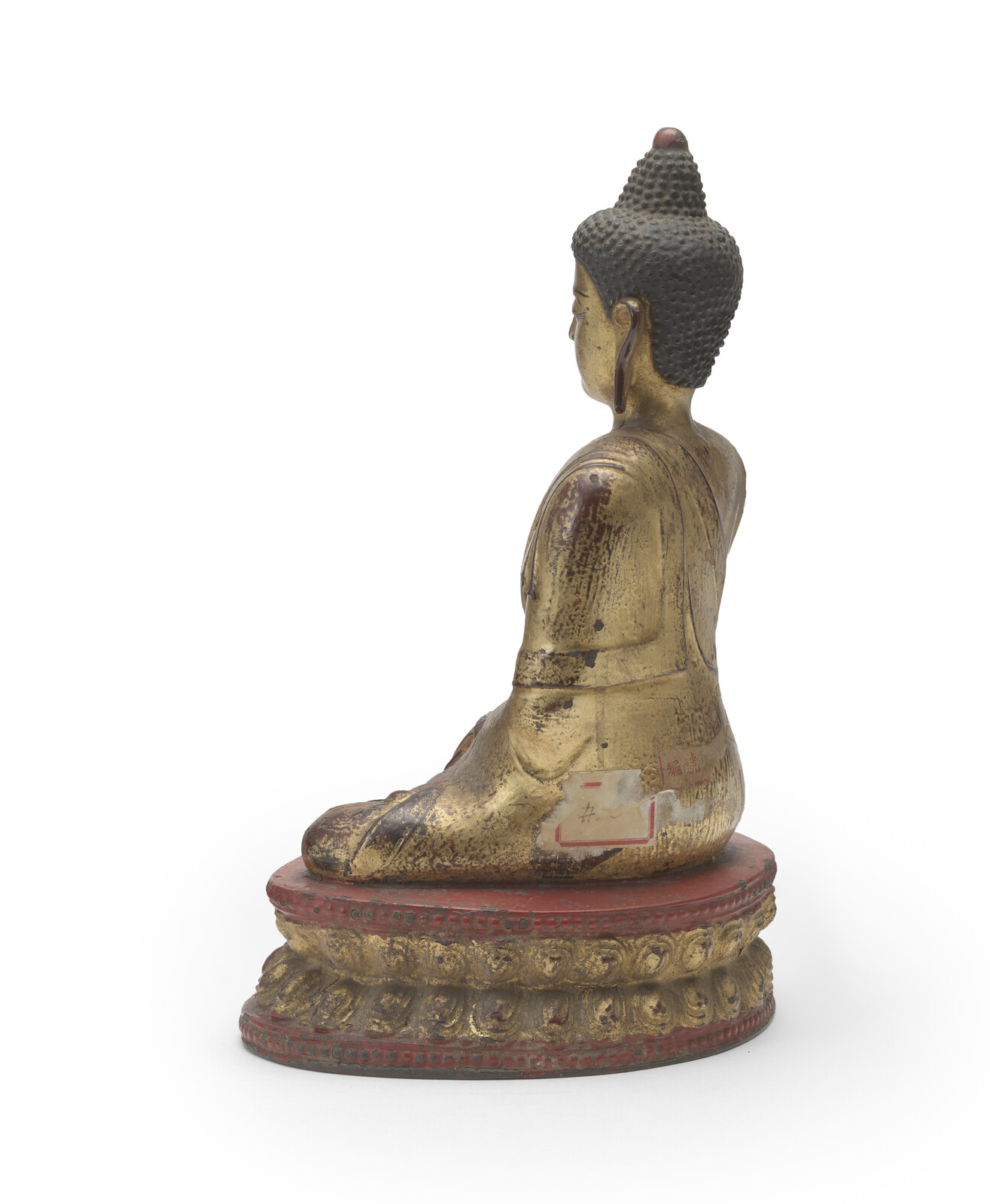 WF 21 A gilt and lacquered bronze figure of Shakyamuni Buddha<br><br>明十六世紀 銅鎏金髹漆釋迦牟尼佛坐像