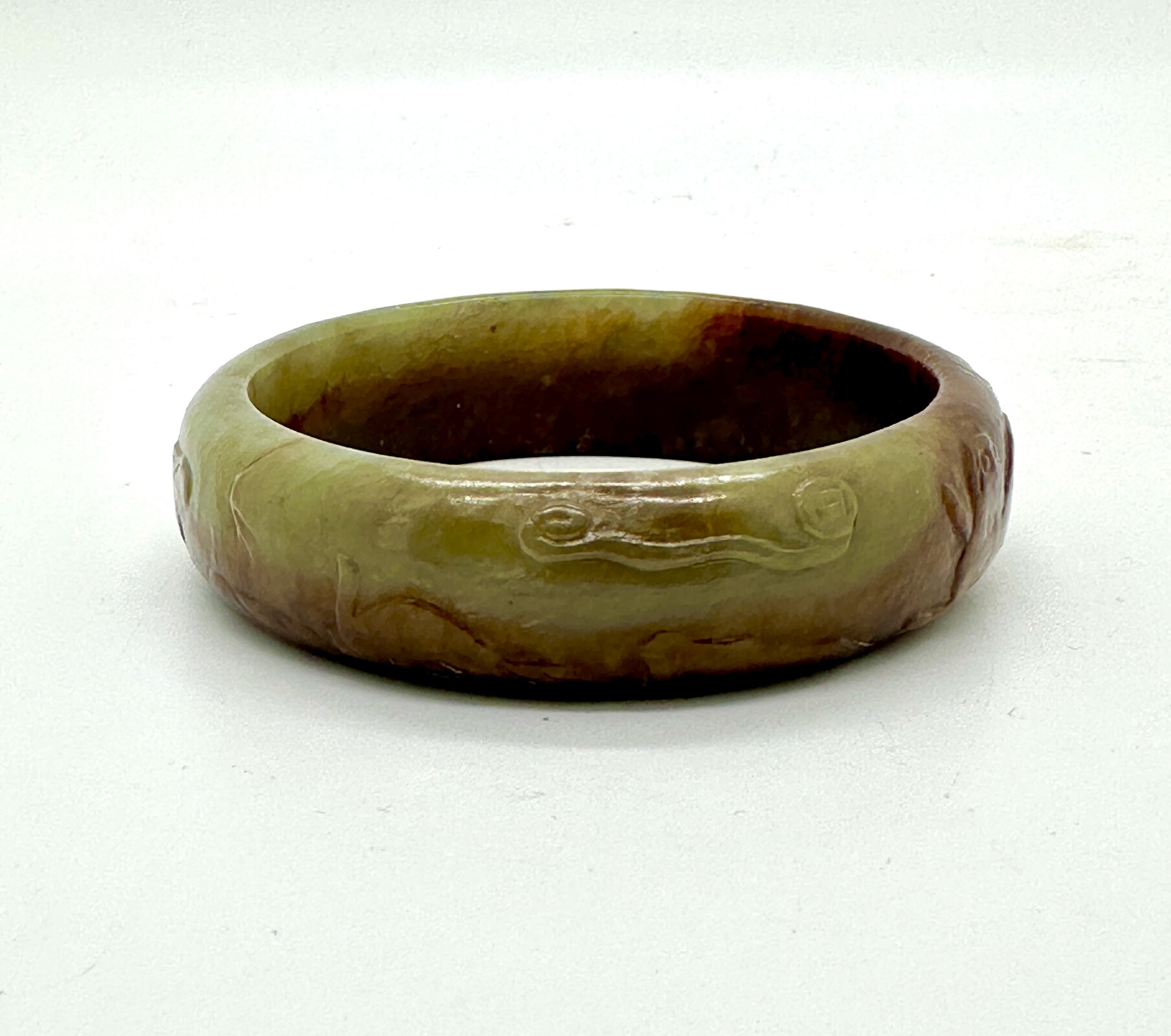 WF48 A celadon green and russet jade bangle