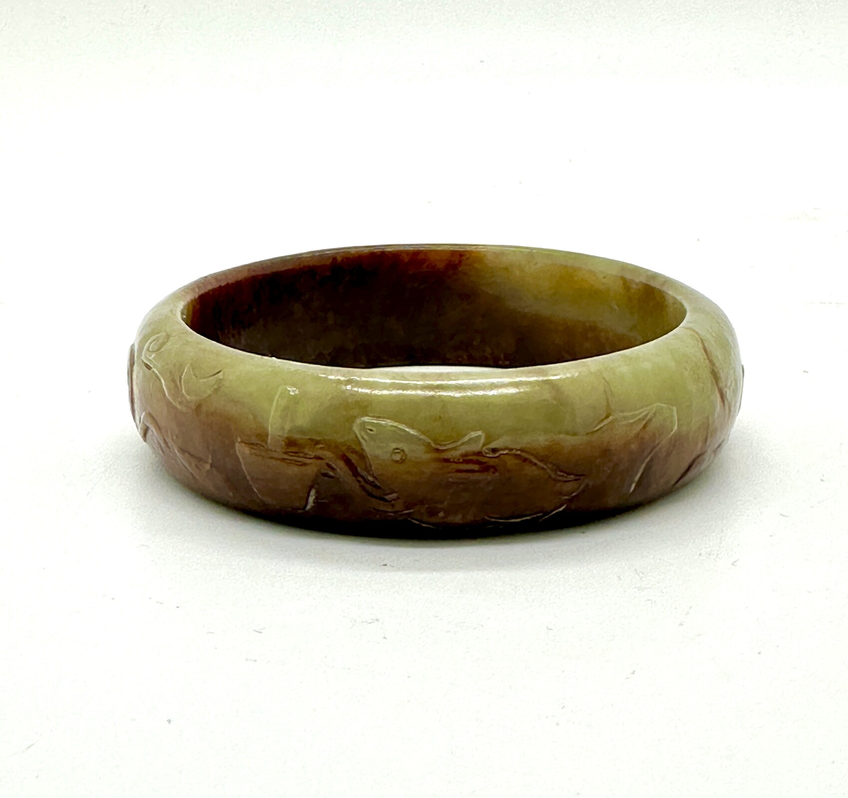 WF48 A celadon green and russet jade bangle