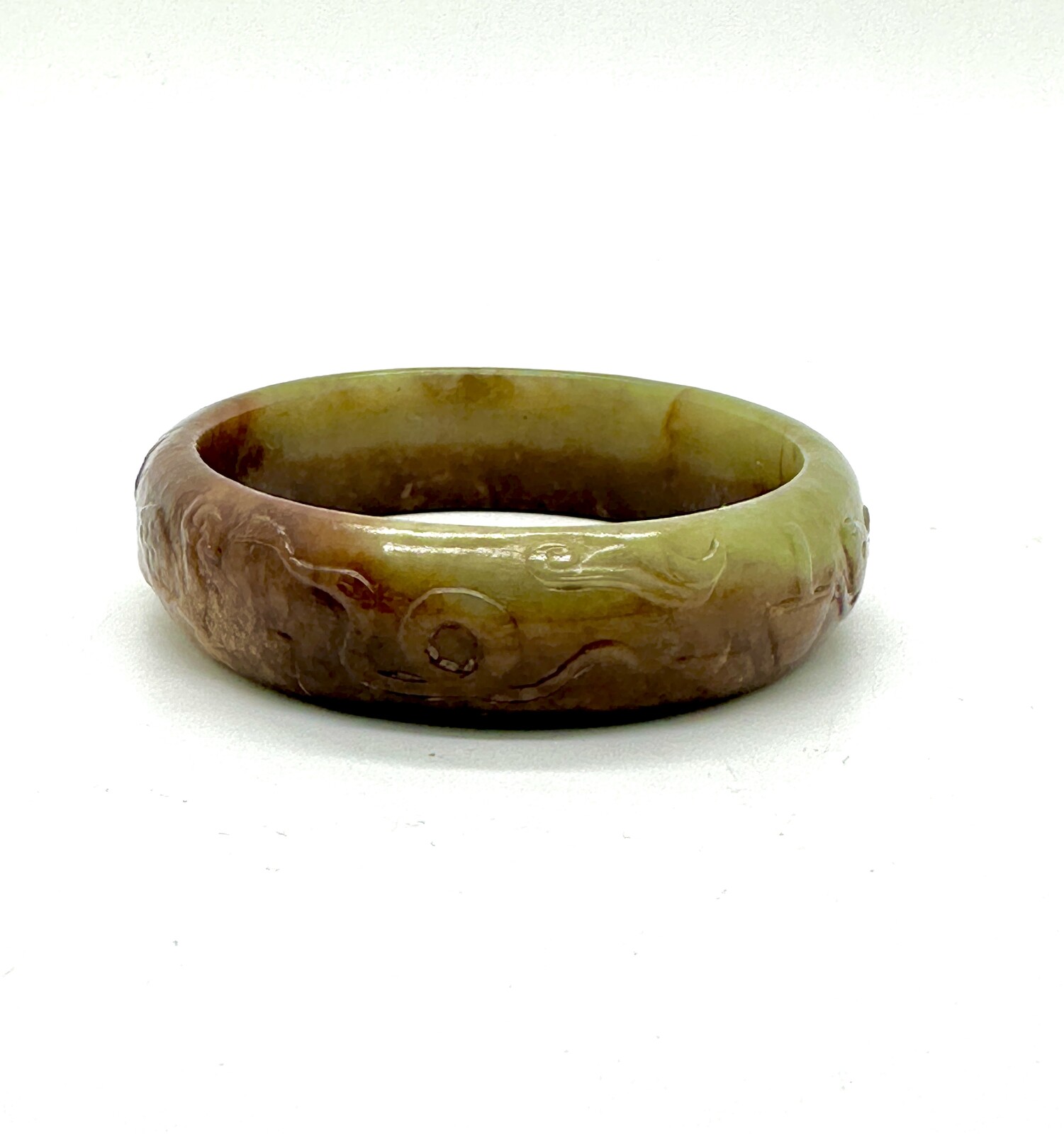 WF48 A celadon green and russet jade bangle